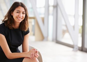 portrait-of-young-business-woman-sitting-in-office portrait-of-young-business-woman-sitting-in-office