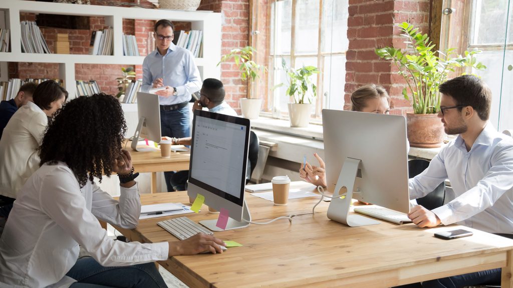 Group of professionals looking focused in a bright and modern office setting