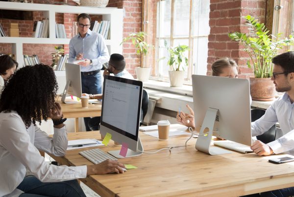 Group of professionals looking focused in a bright and modern office setting