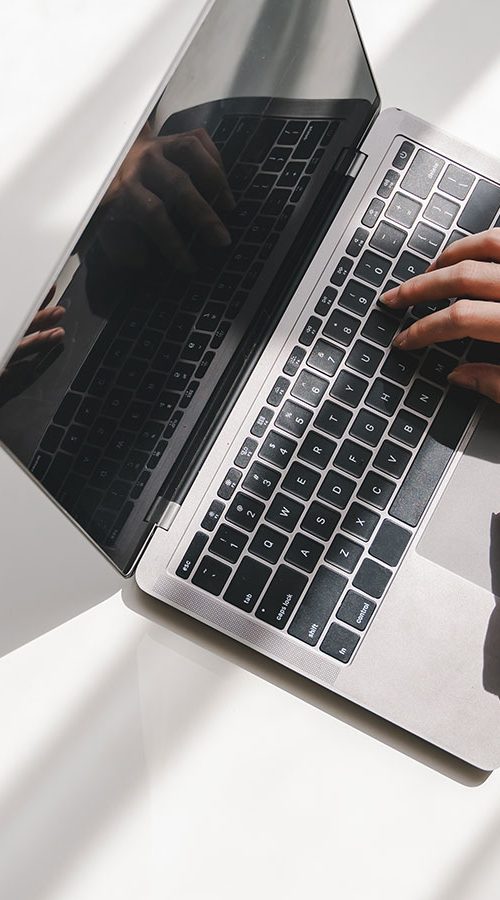 hands typing on a laptop