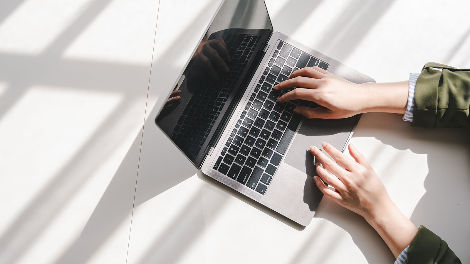 hands typing on a laptop