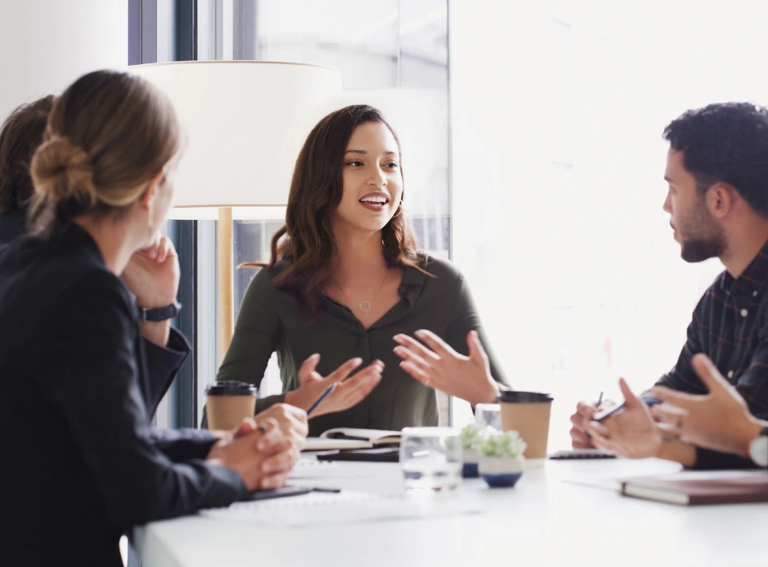 A team member presenting ideas to colleagues around a meeting table