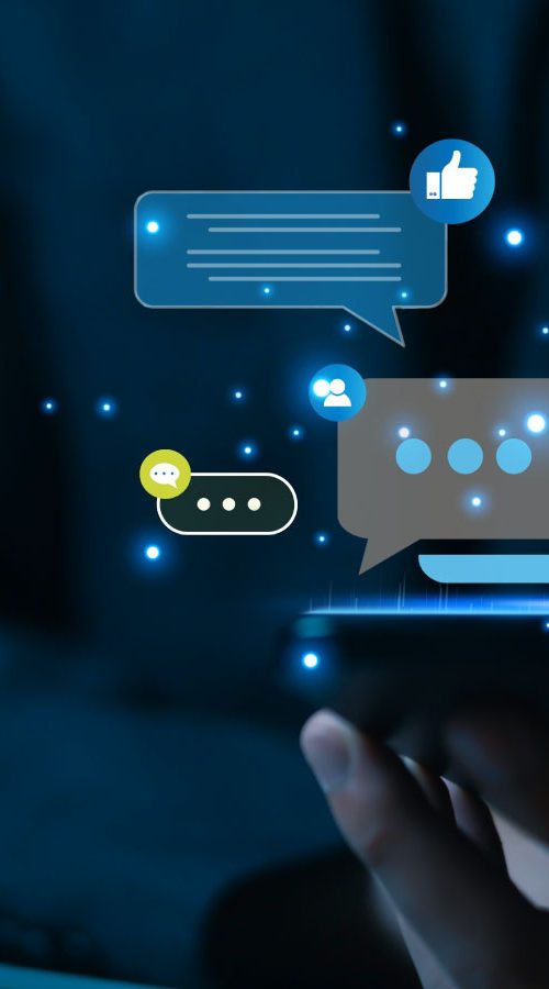 a hand holding a phone with illustrative chat bubbles popping up from the device